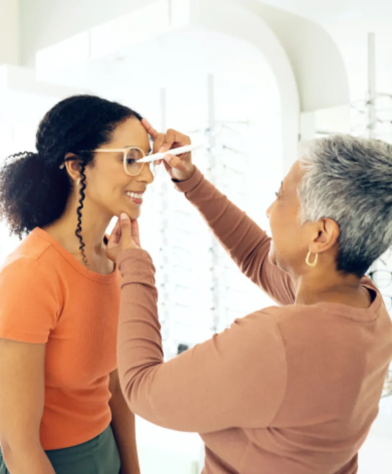 Optician adjusts a customer’s eyeglass frames during a personalized fitting
