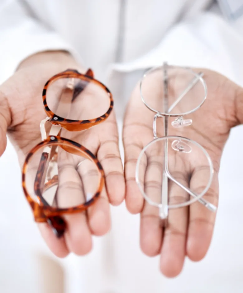 Eye-care professional presenting two eyeglass frame styles